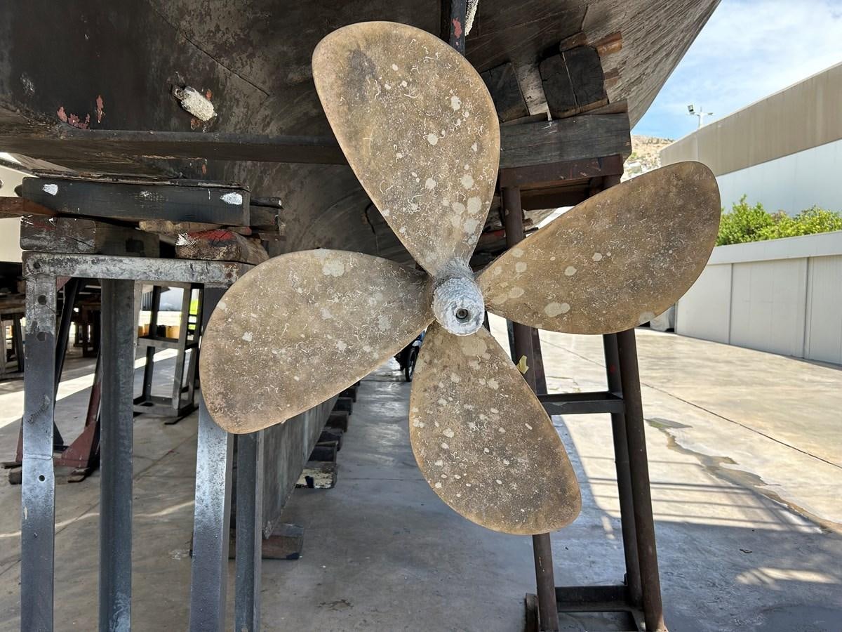 a wooden wheel with a large wheel aboard MOTORSAILLOR Yacht for Sale