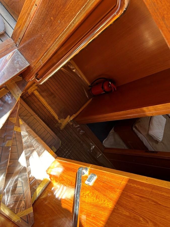 a red shoe on a wooden surface aboard MOTORSAILLOR Yacht for Sale