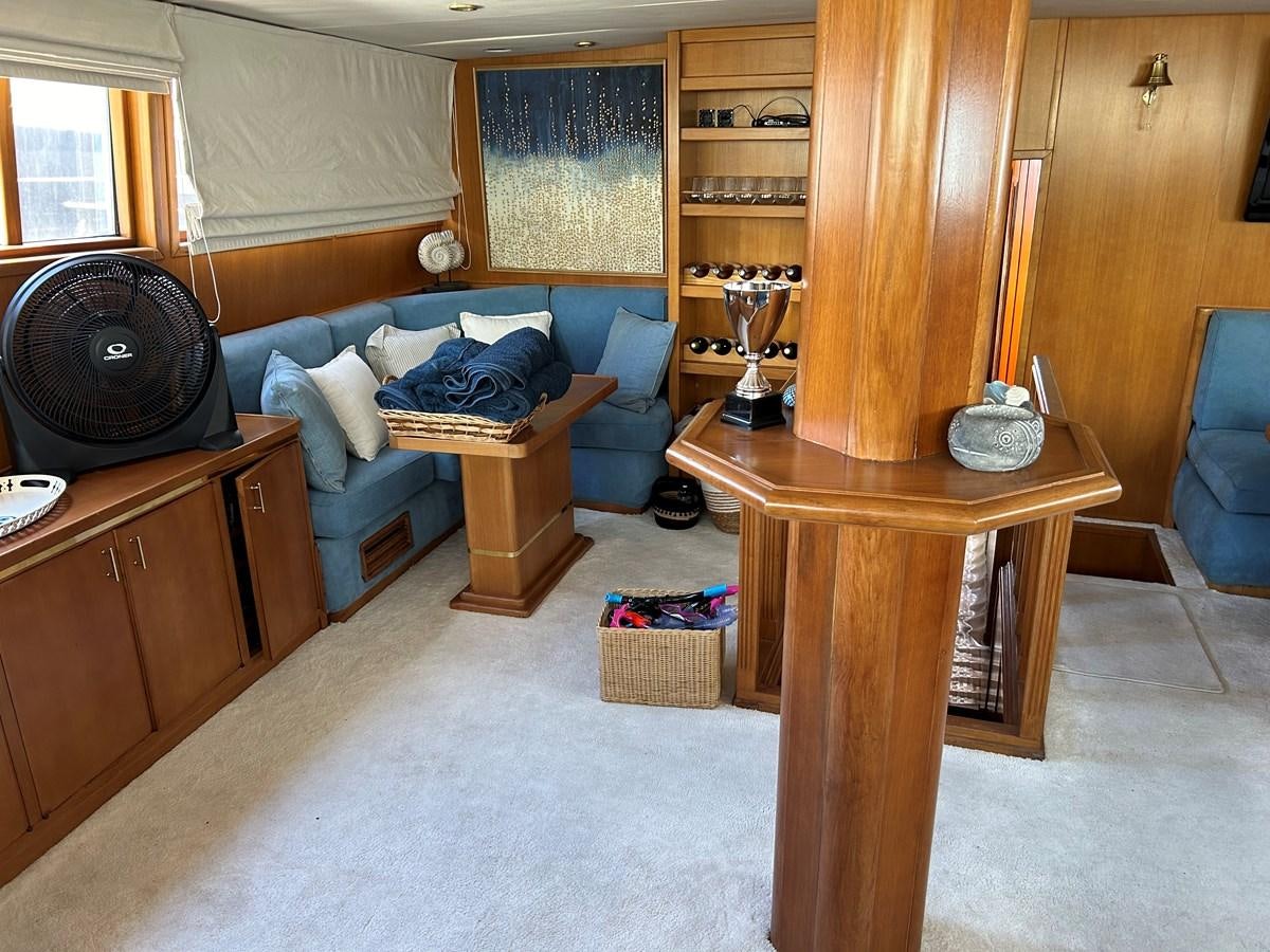 a living room with a couch and a table aboard MOTORSAILLOR Yacht for Sale