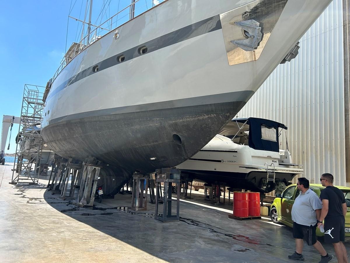 a large airplane is being loaded aboard MOTORSAILLOR Yacht for Sale