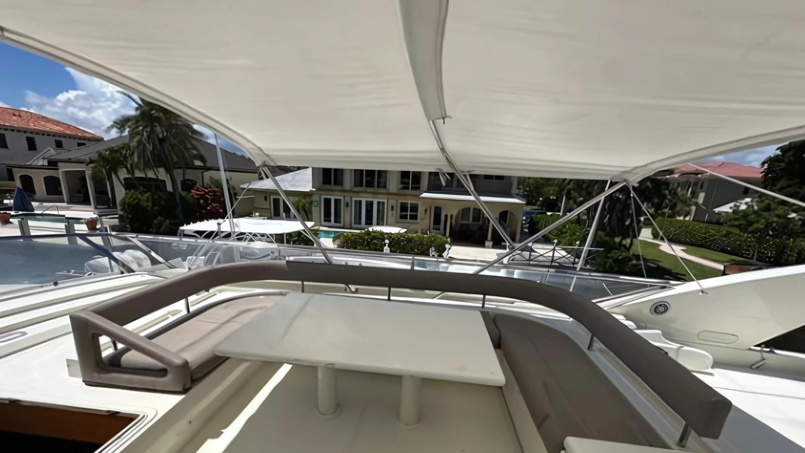 a white tent with a table and chairs in front of it aboard 1998 FERRETTI 80FT Yacht for Sale