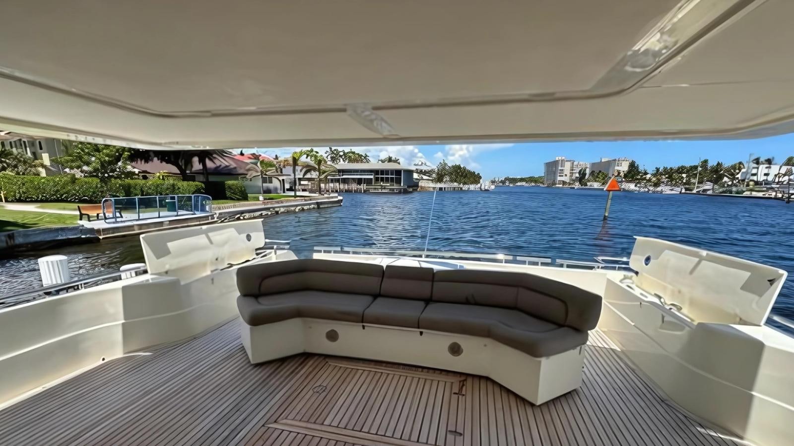 a pool with a deck and a city in the background aboard 1998 FERRETTI 80FT Yacht for Sale