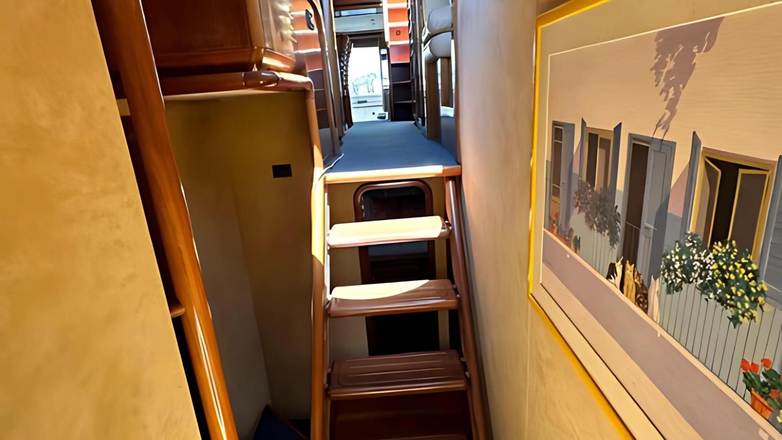 a room with a chair and a table and a window aboard 1998 FERRETTI 80FT Yacht for Sale