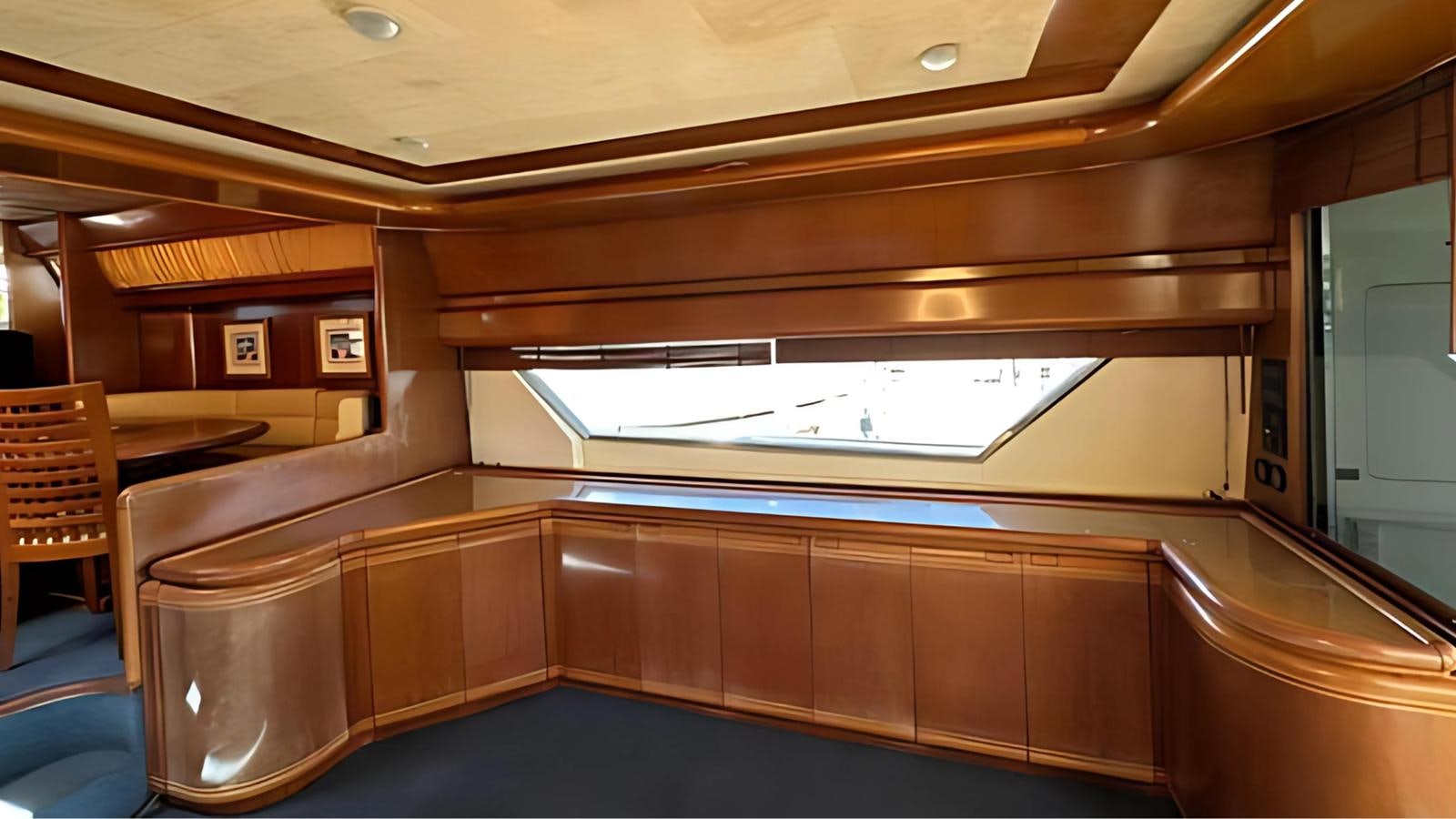 a room with a window and chairs aboard 1998 FERRETTI 80FT Yacht for Sale