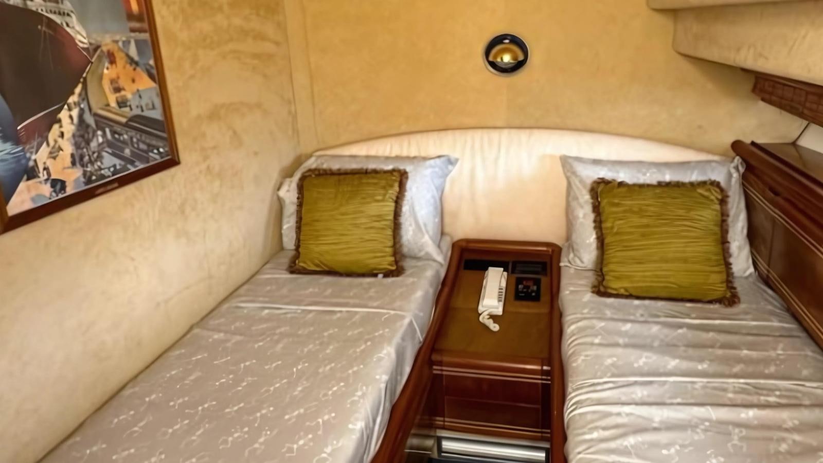 a bed with a wooden headboard and a dresser with a painting on it aboard 1998 FERRETTI 80FT Yacht for Sale