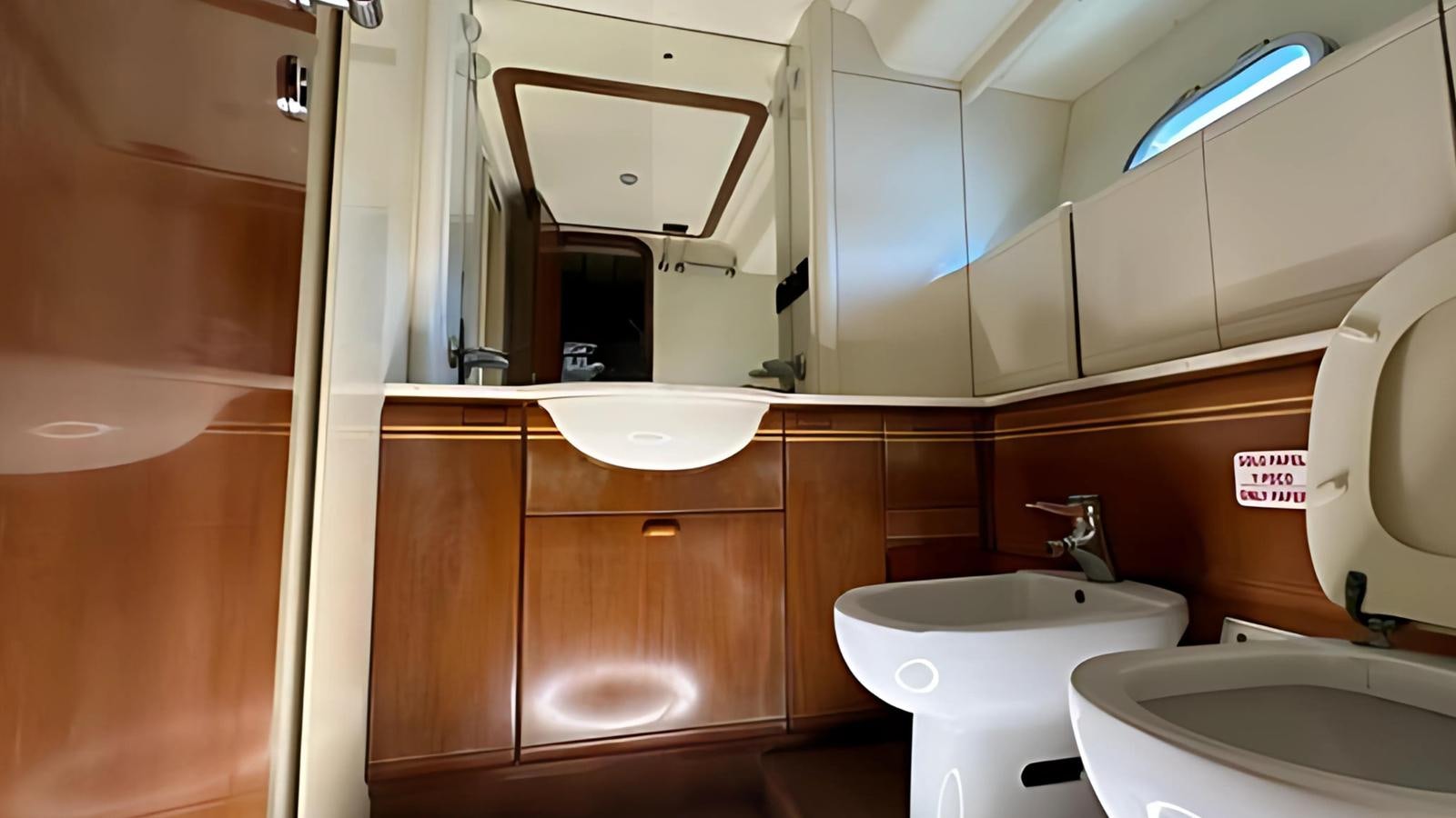 a bathroom with a sink and a toilet aboard 1998 FERRETTI 80FT Yacht for Sale