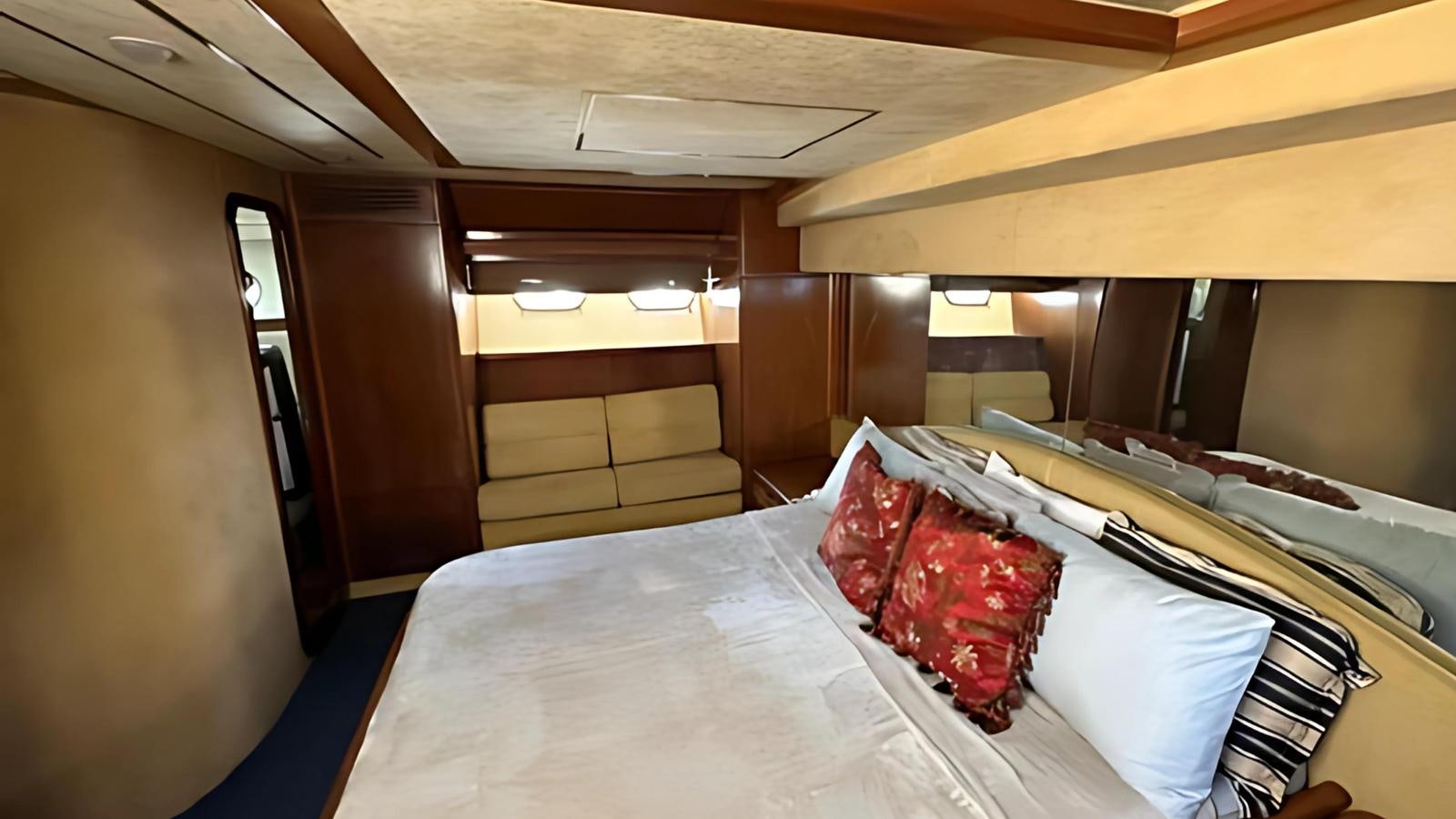 a room with a bed and a table aboard 1998 FERRETTI 80FT Yacht for Sale