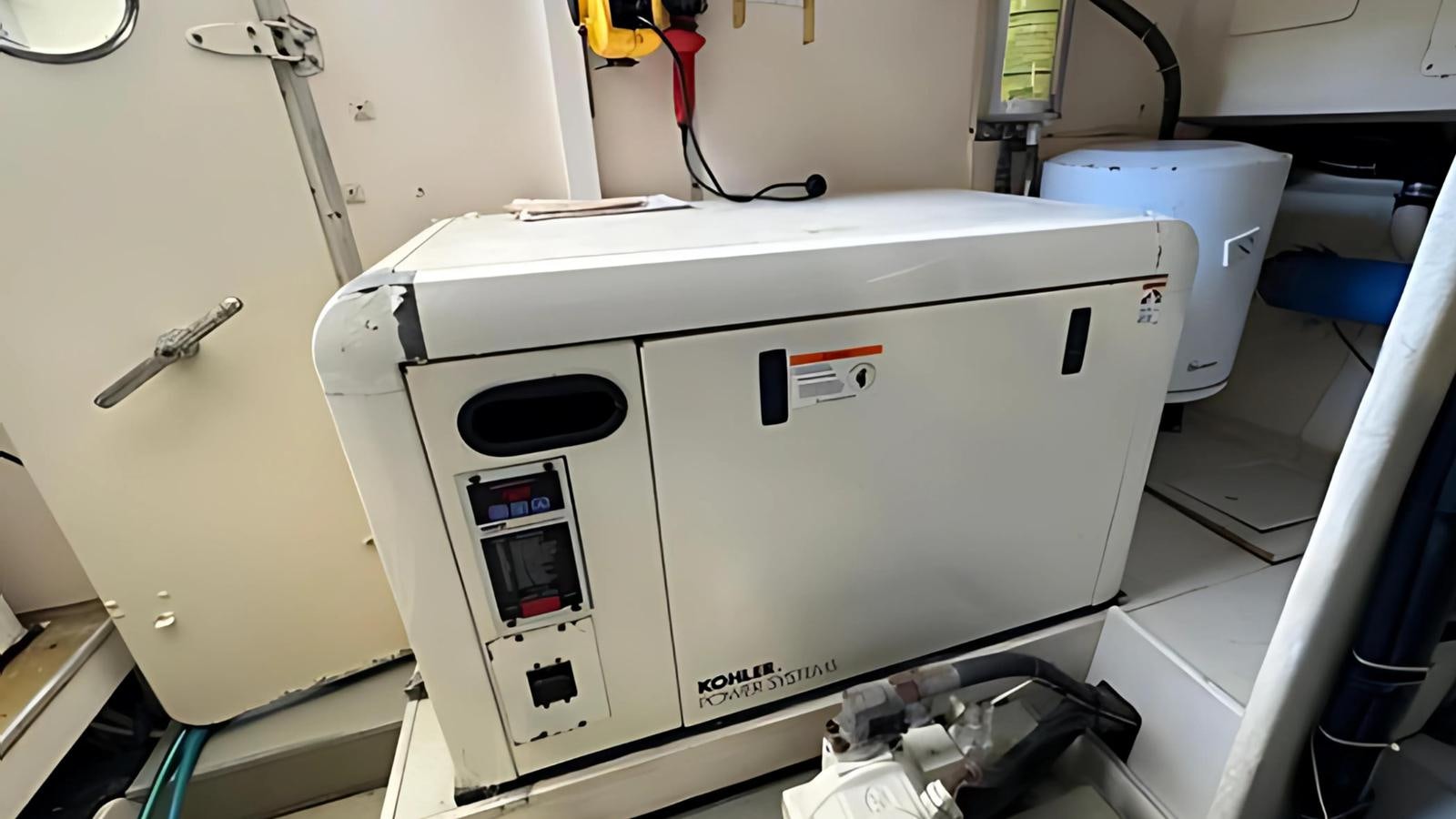 a white machine with a red label aboard 1998 FERRETTI 80FT Yacht for Sale