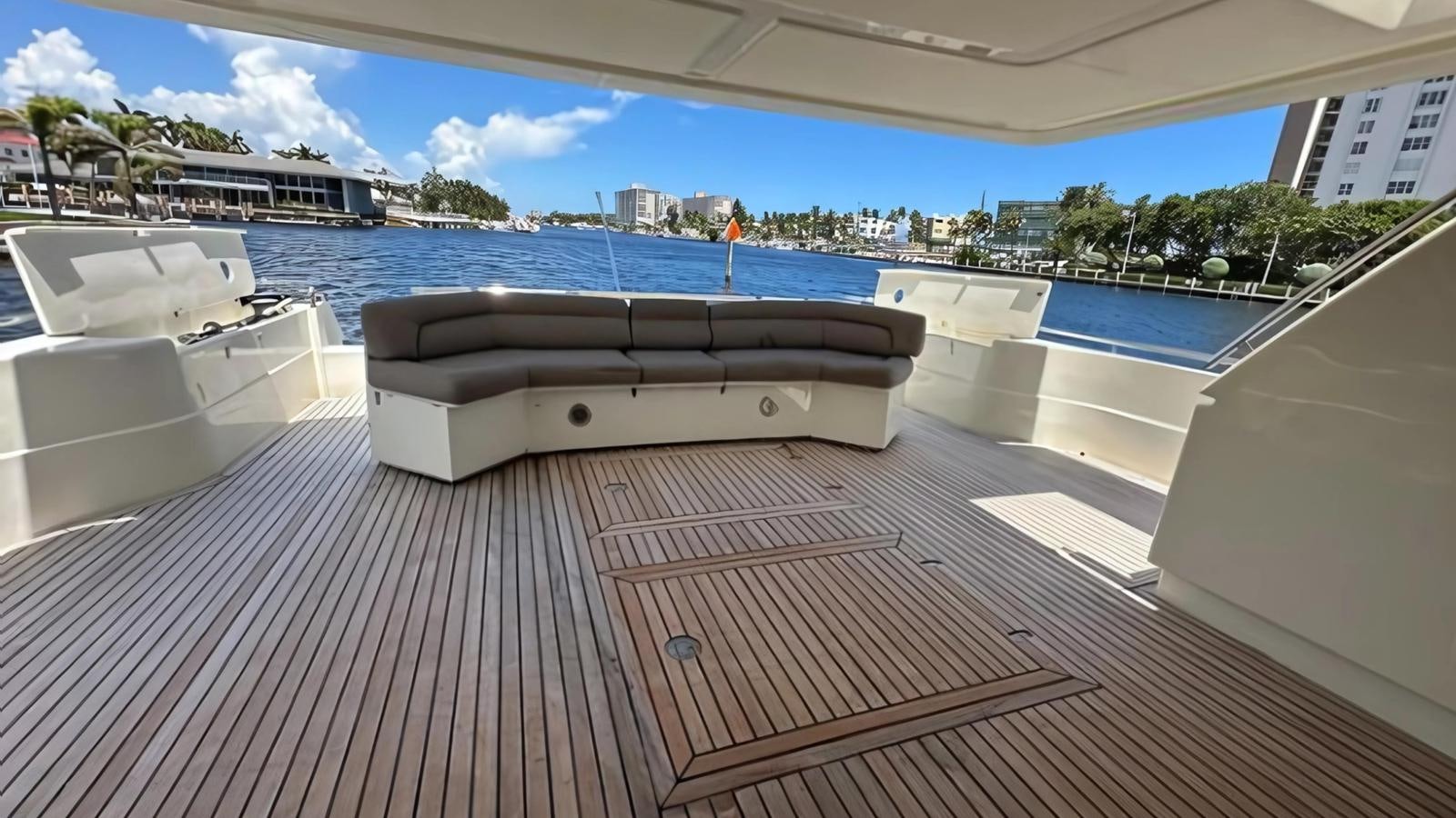 a deck with a pool and a deck with a large building and trees aboard 1998 FERRETTI 80FT Yacht for Sale