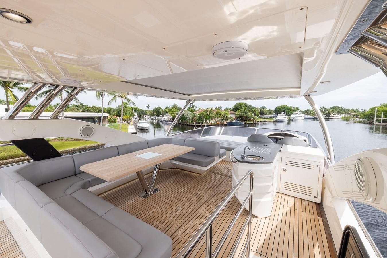 a boat with a deck and a table and chairs aboard 2018 SUNSEEKER 75 YACHT Yacht for Sale