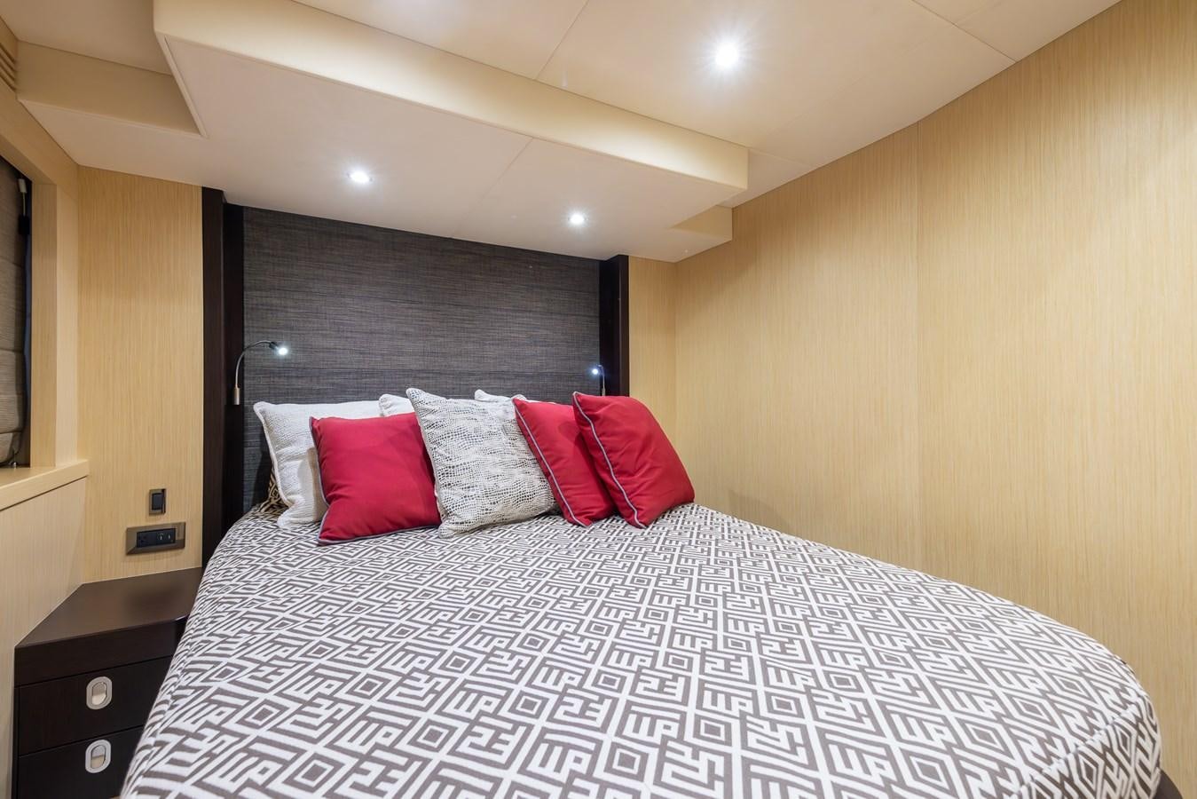 a bed with red pillows aboard 2018 SUNSEEKER 75 YACHT Yacht for Sale