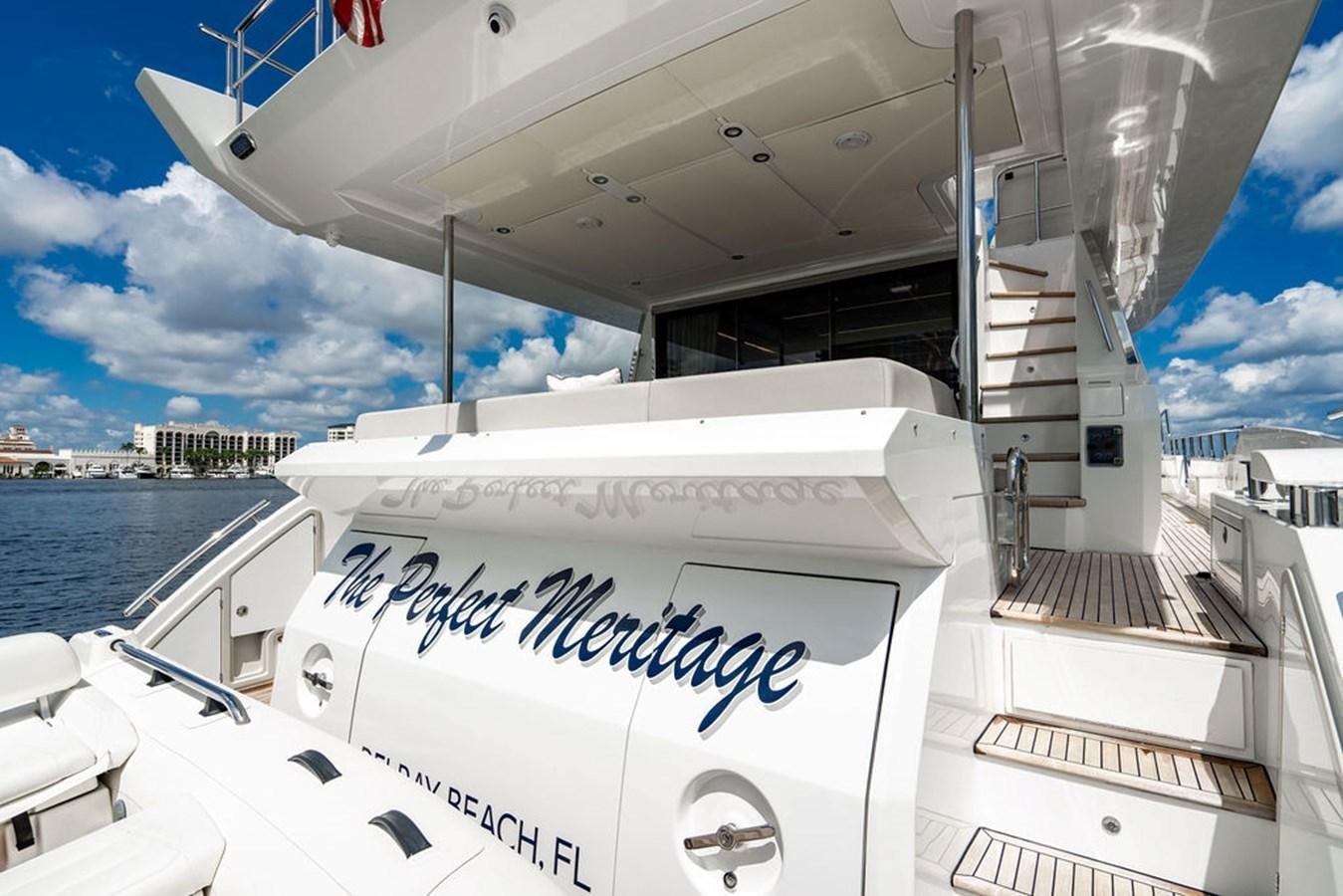 a white boat with a sign on it aboard THE PERFECT MERITAGE Yacht for Sale