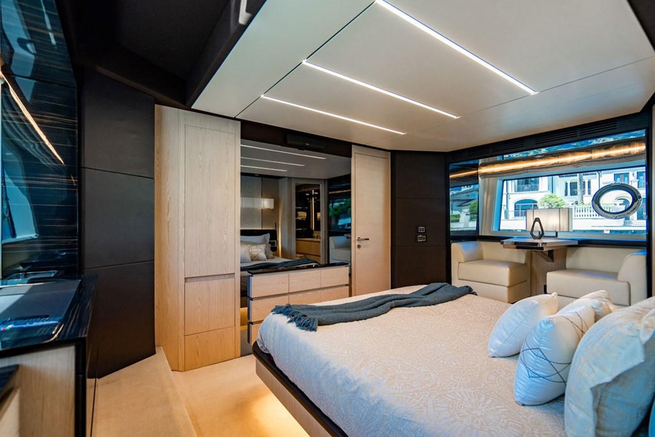 a bedroom with a bed and a desk aboard THE PERFECT MERITAGE Yacht for Sale