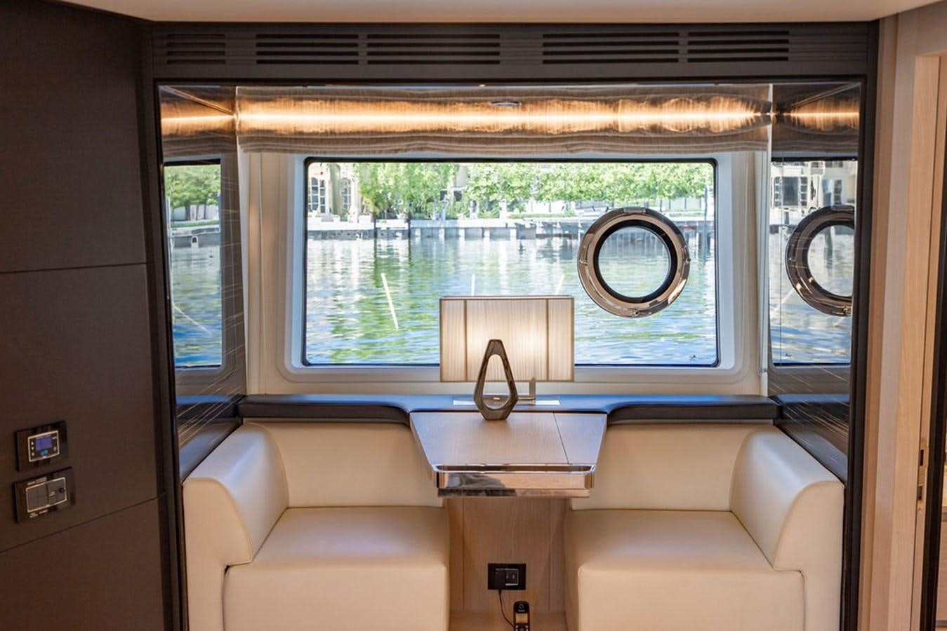 a room with a couch and a window aboard THE PERFECT MERITAGE Yacht for Sale