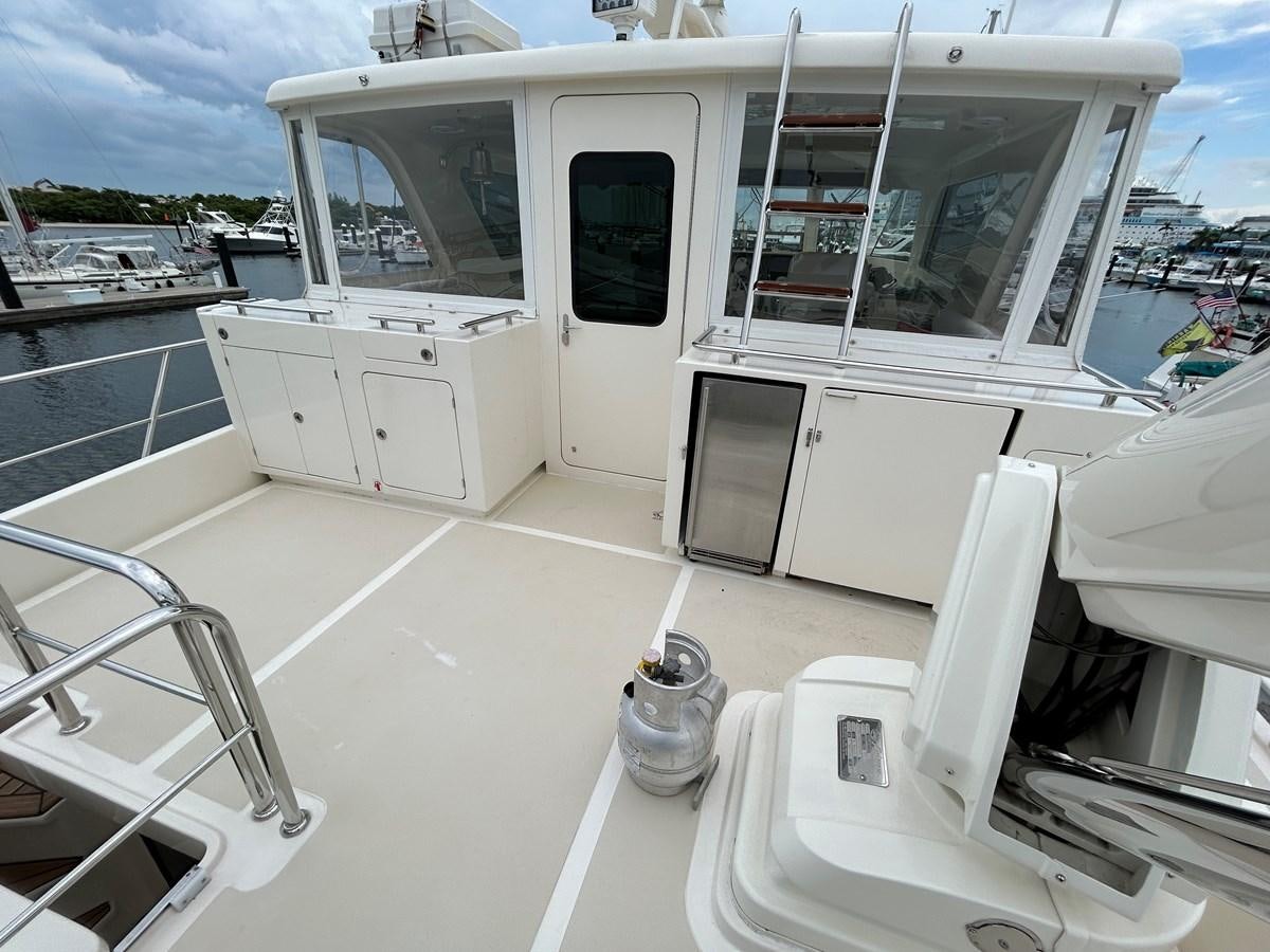 a white boat on a dock aboard NOVIA II Yacht for Sale