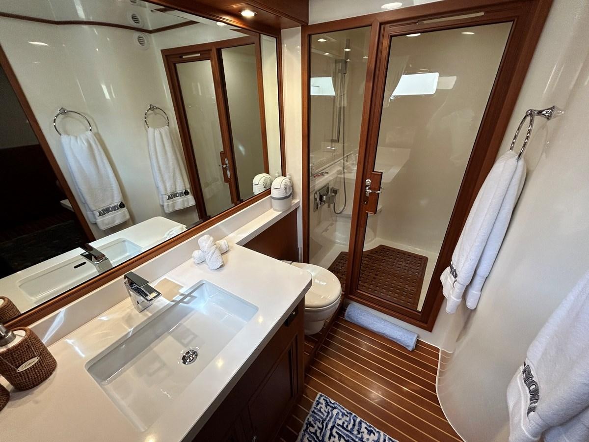 a bathroom with a sink and a mirror aboard NOVIA II Yacht for Sale