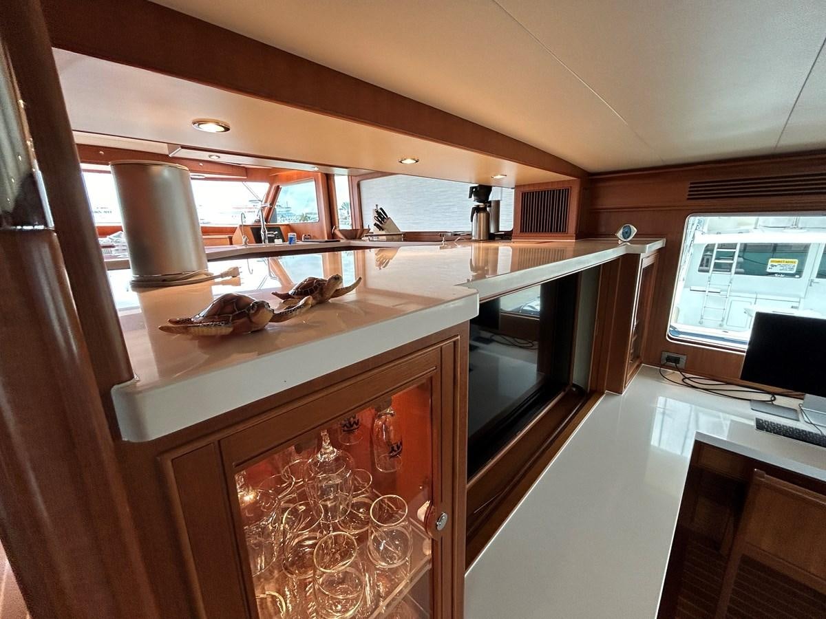 a kitchen with a wood cabinet aboard NOVIA II Yacht for Sale