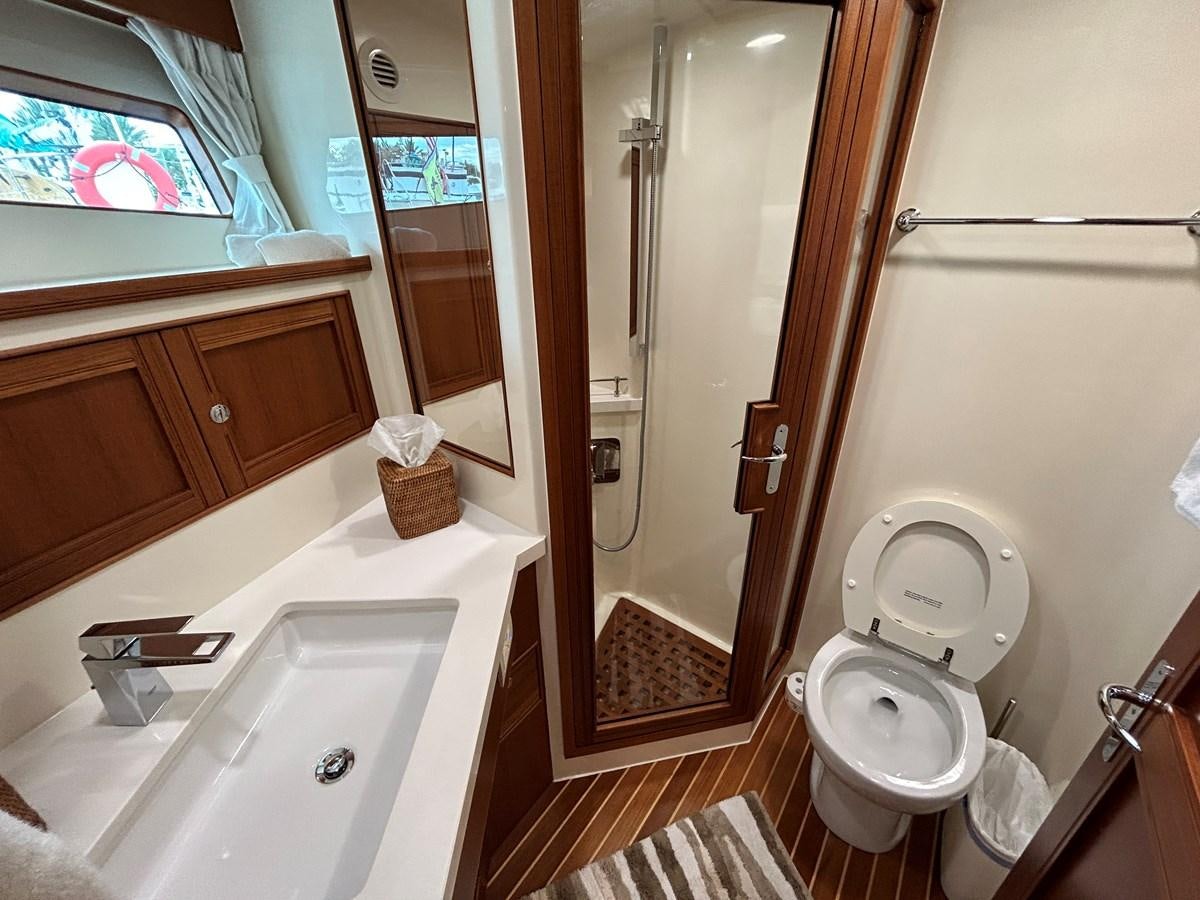 a bathroom with a toilet sink and a mirror aboard NOVIA II Yacht for Sale