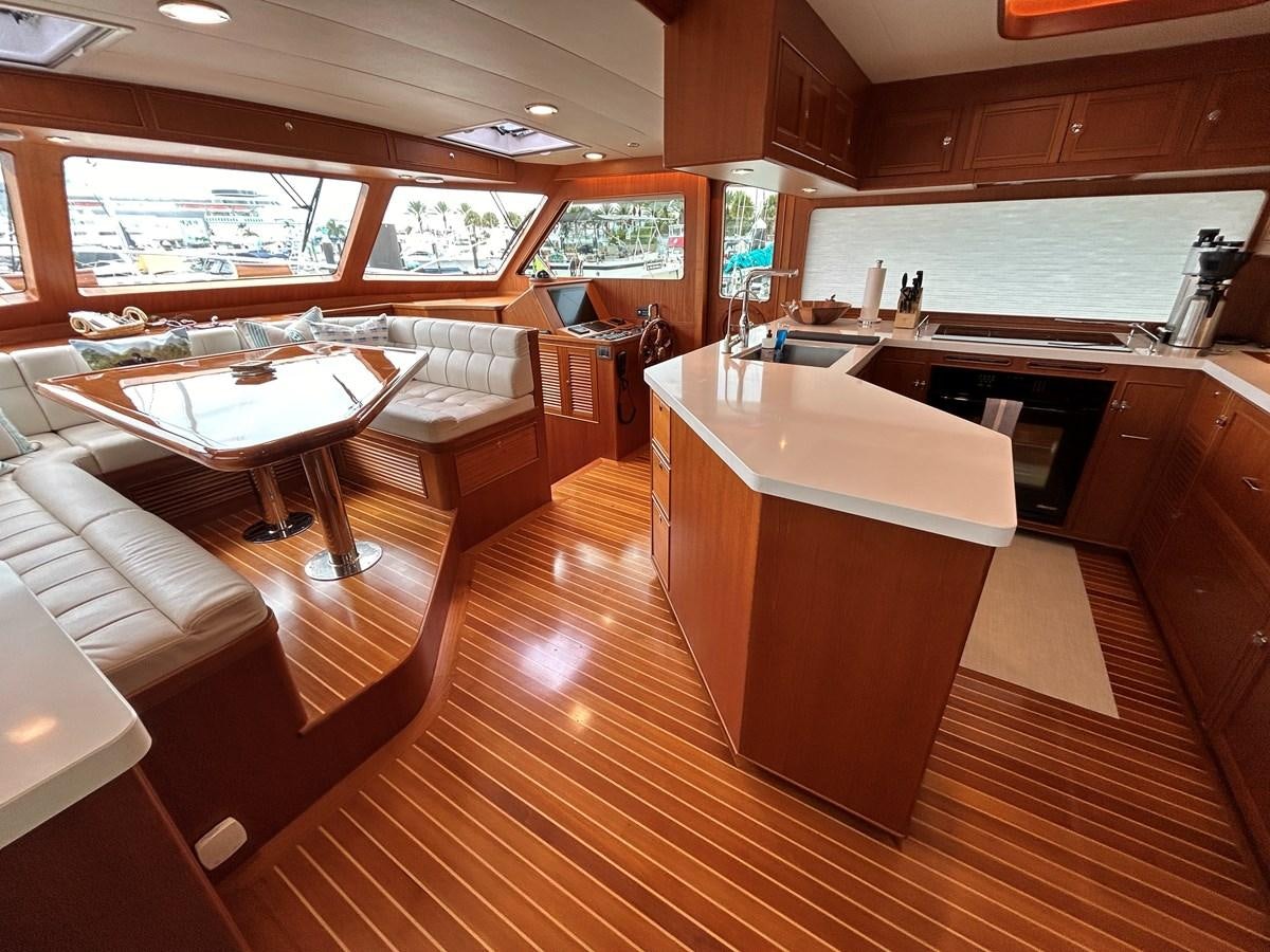 a large kitchen with wooden cabinets aboard NOVIA II Yacht for Sale