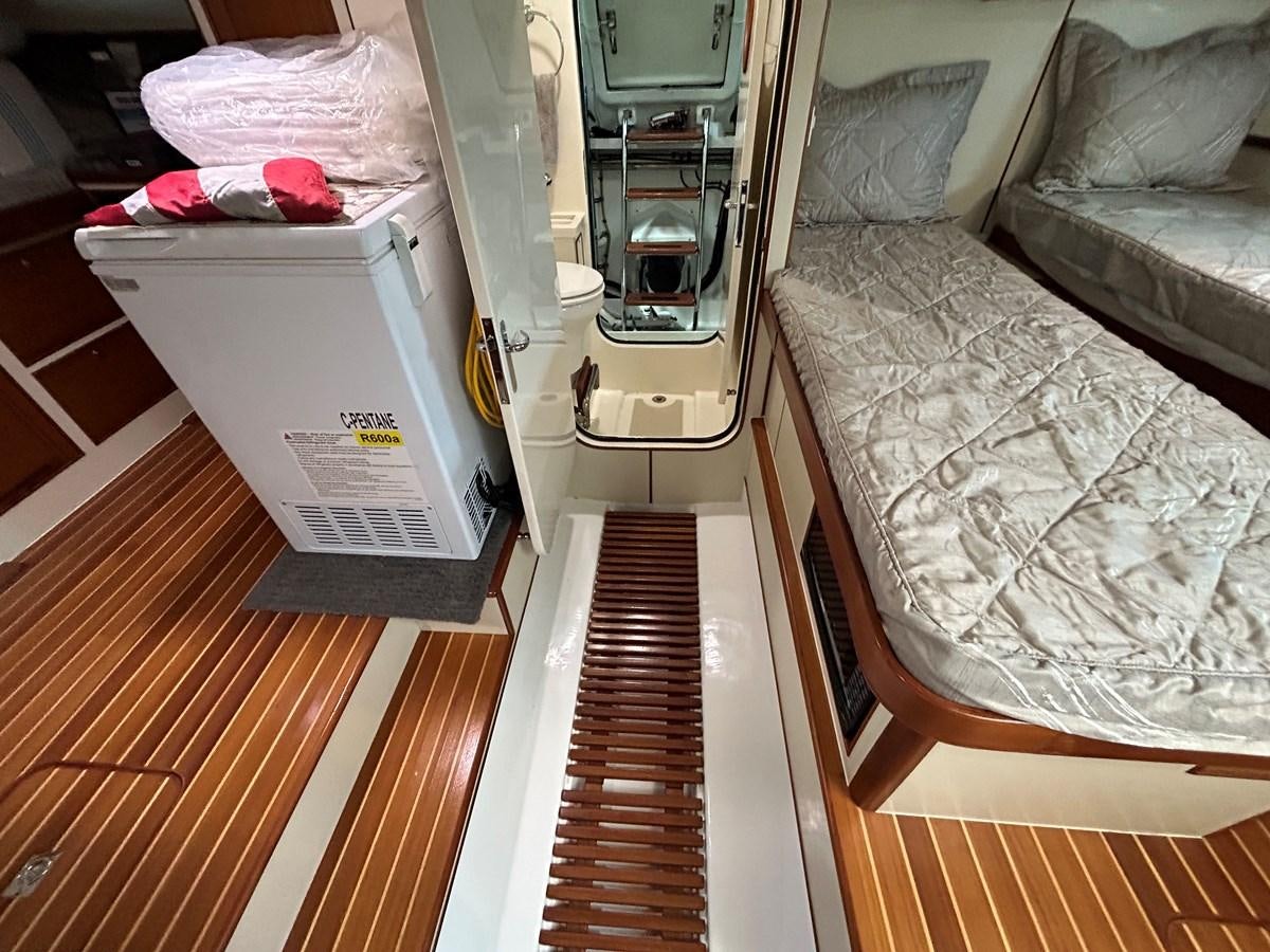 a room with a bed and a table aboard NOVIA II Yacht for Sale