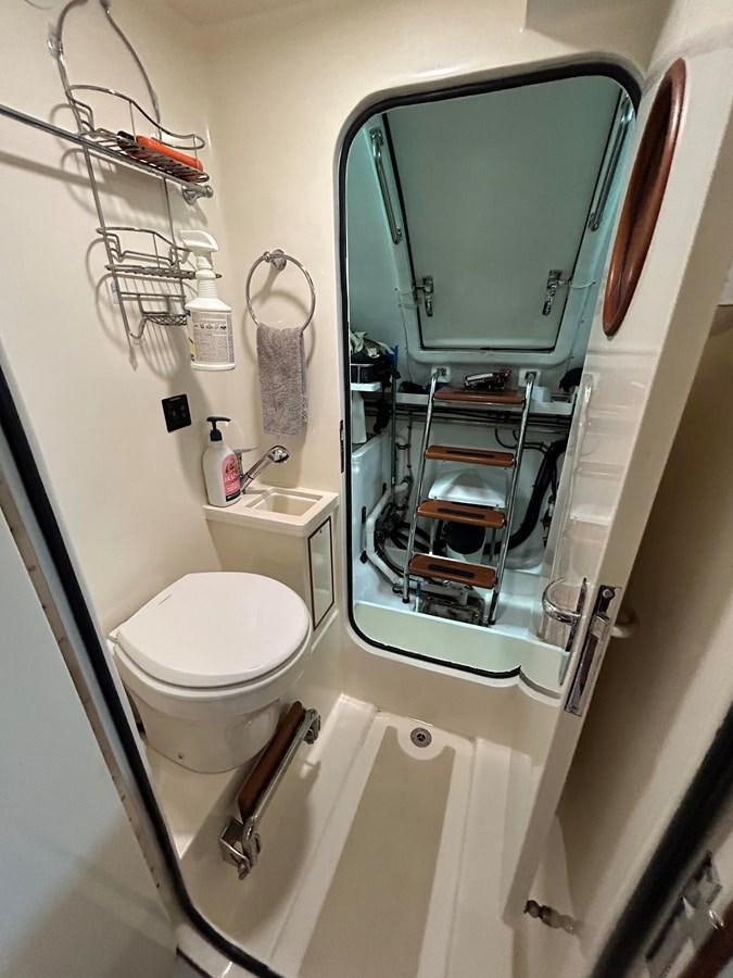 a bathroom with a mirror and toilet aboard NOVIA II Yacht for Sale