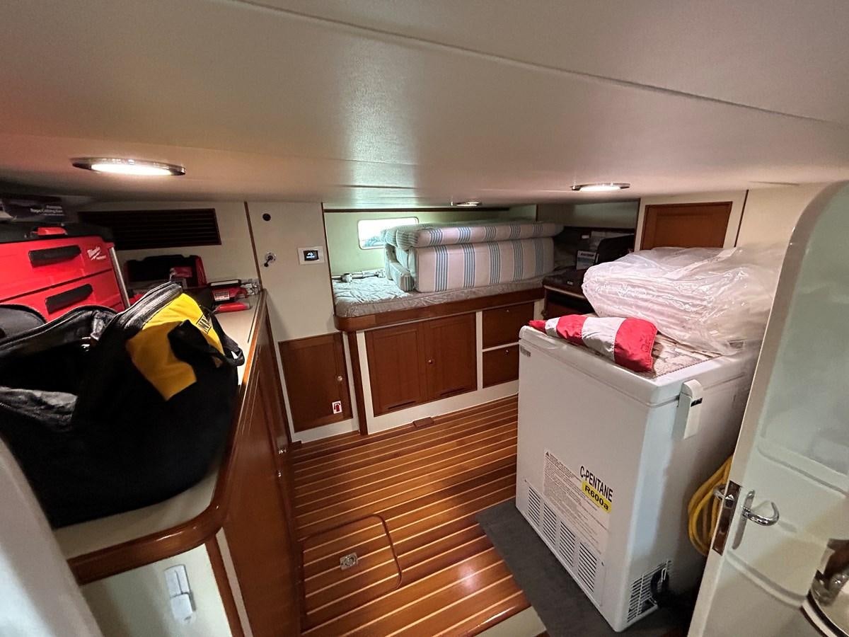 a room with a bed and a desk aboard NOVIA II Yacht for Sale