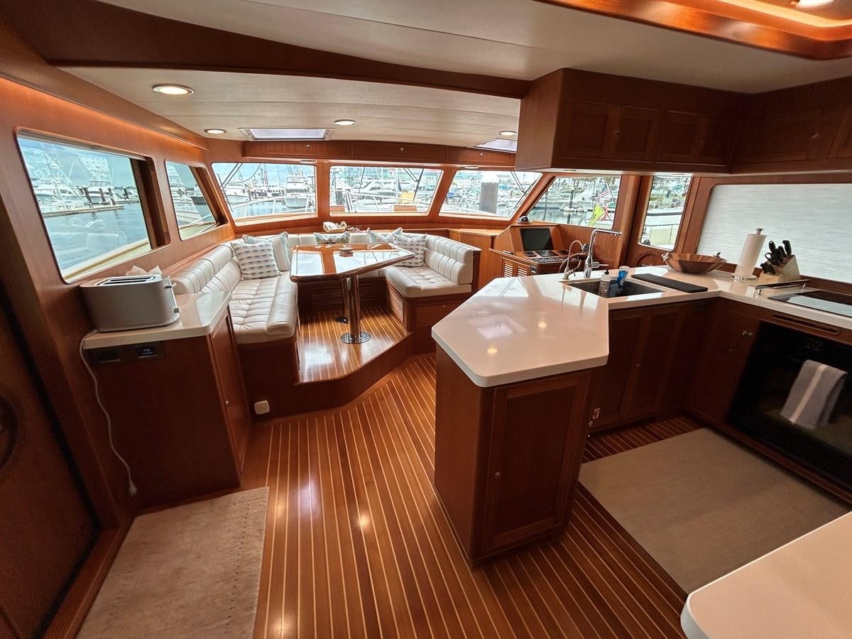a room with a table chairs and a window aboard NOVIA II Yacht for Sale