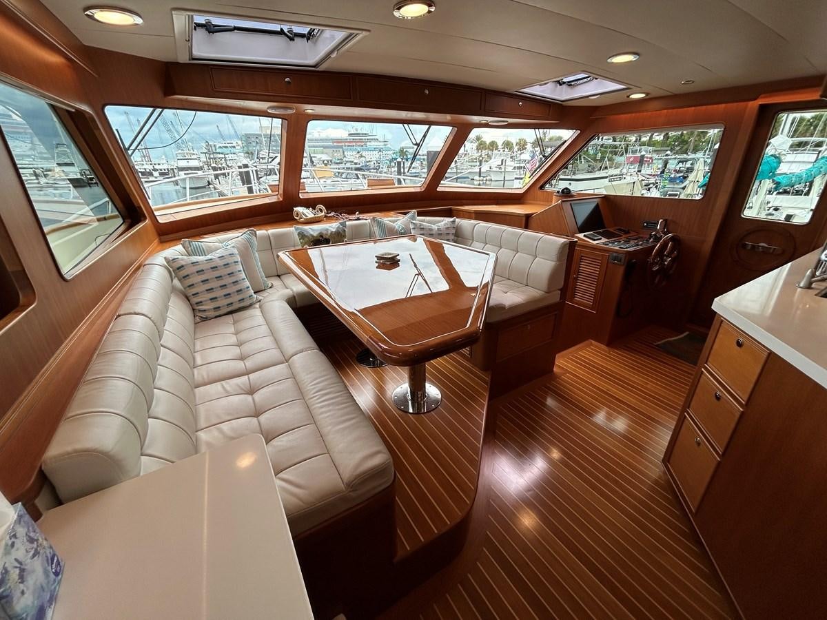 a room with a bed and a table aboard NOVIA II Yacht for Sale