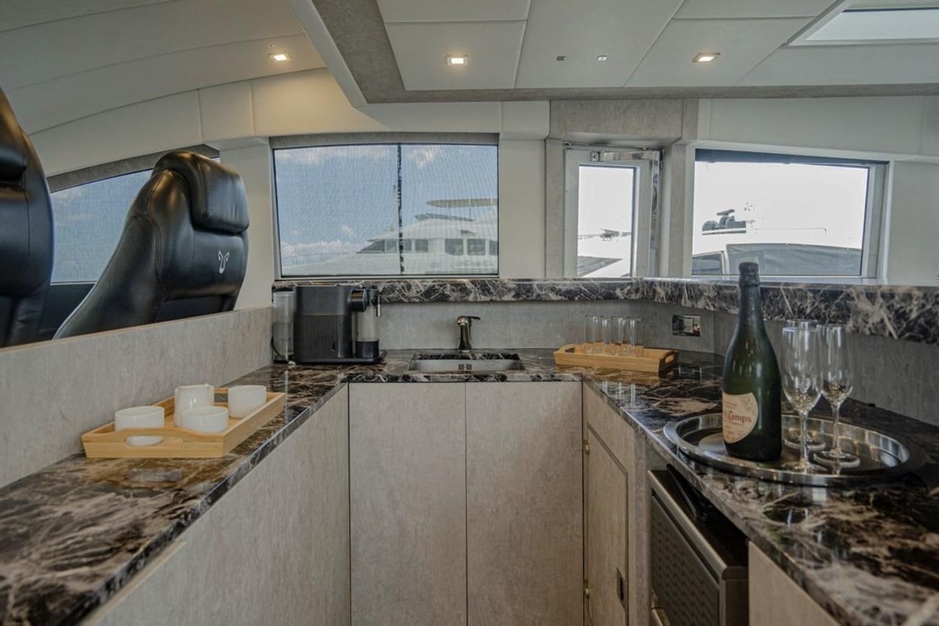 a kitchen with a large sink and a large window aboard LEOPARD 31 OPEN Yacht for Sale
