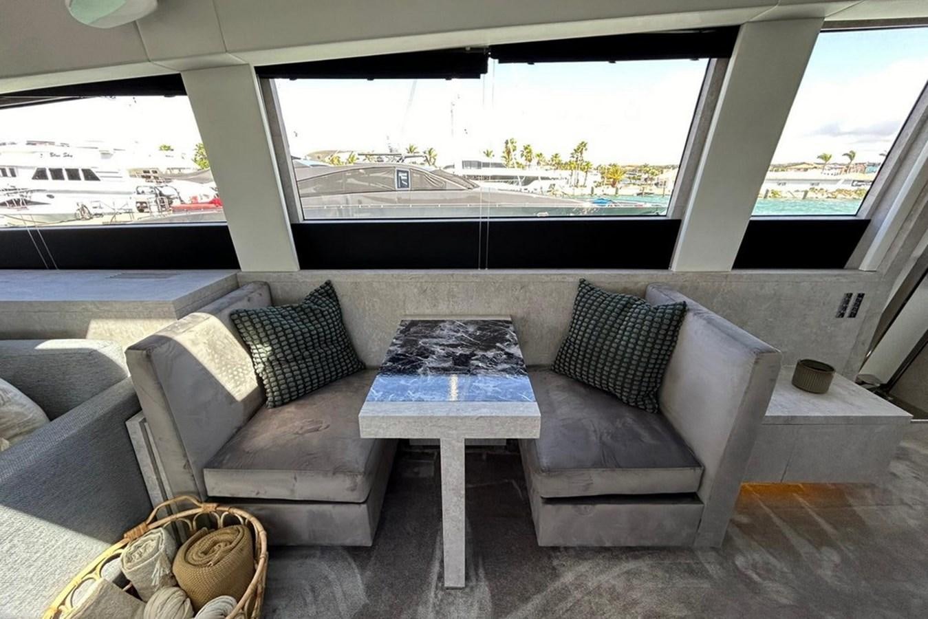 a couch and a table in a room aboard LEOPARD 31 OPEN Yacht for Sale