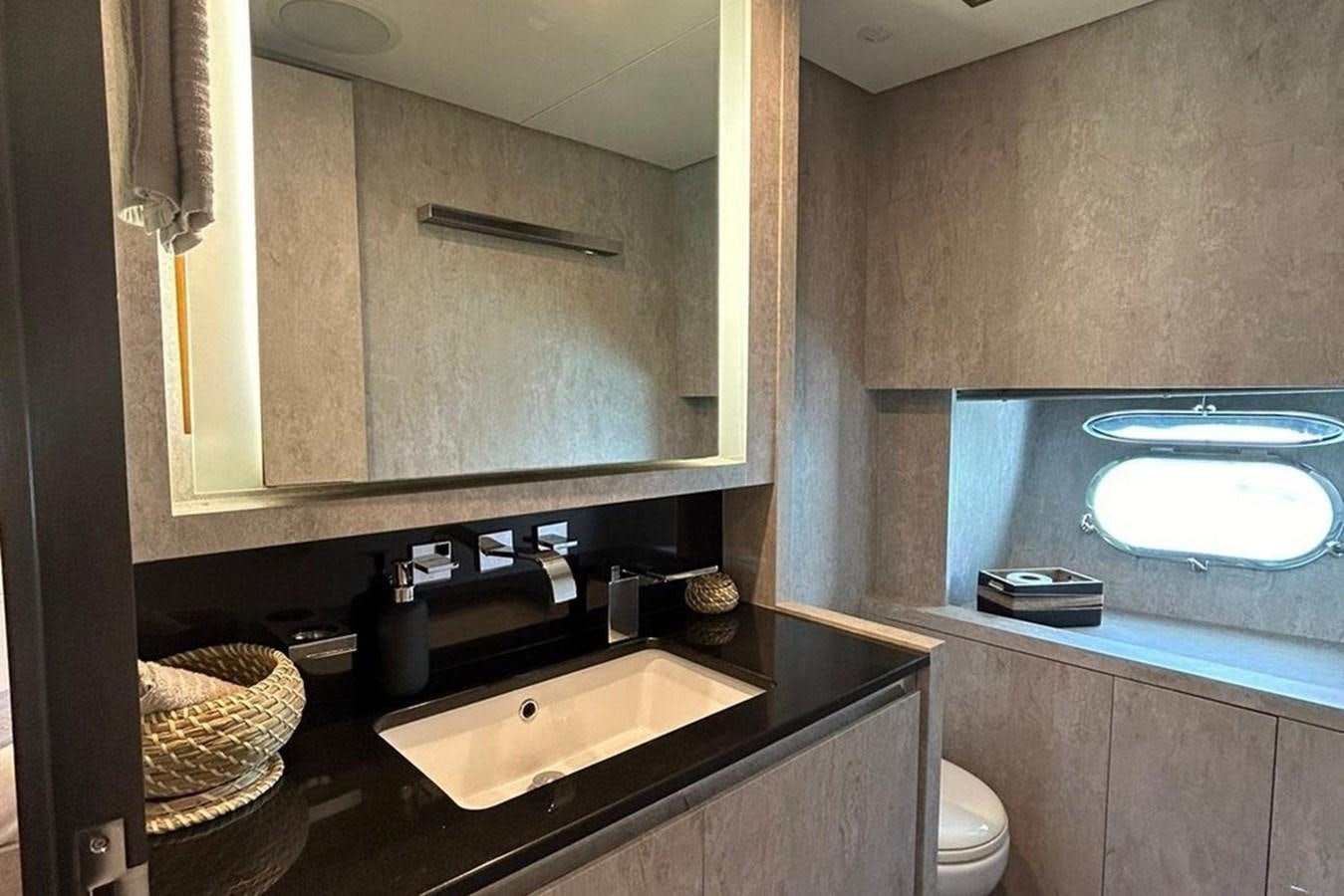 a bathroom with a sink and a mirror aboard LEOPARD 31 OPEN Yacht for Sale