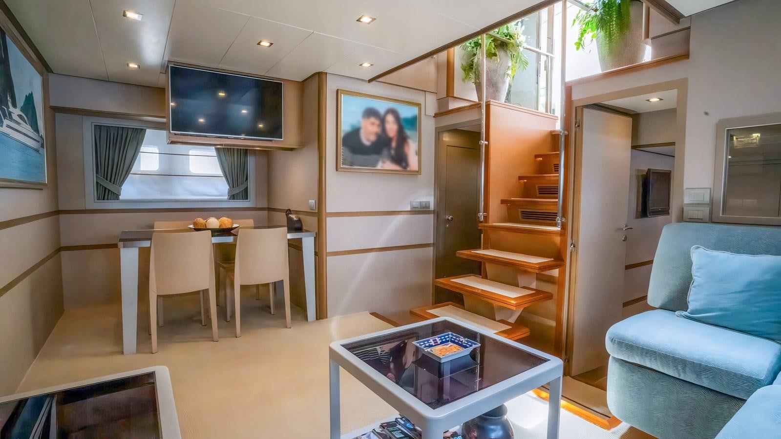 a living room with a table and couches aboard ELEGANCE OF CANNES Yacht for Sale