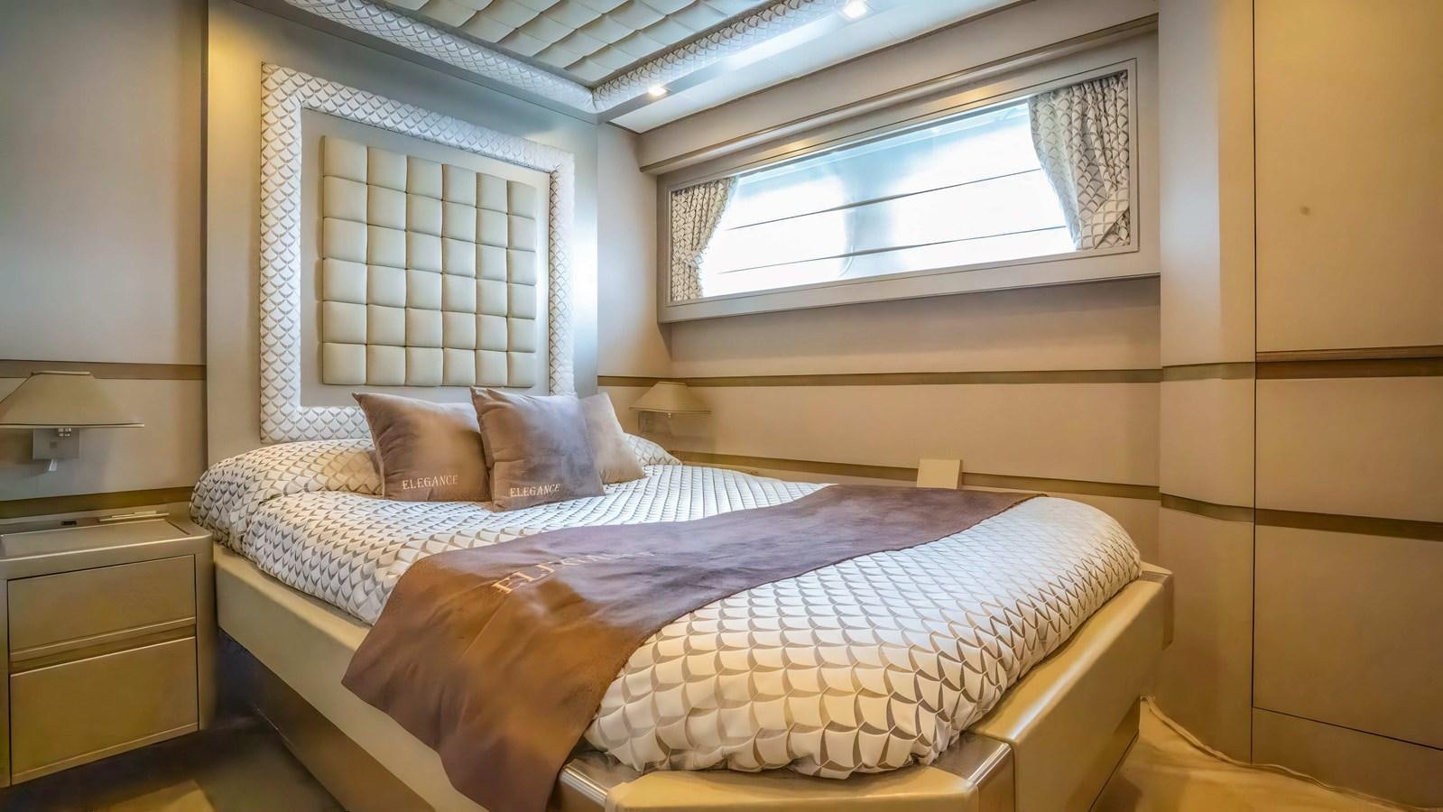 a bed with a purple blanket aboard ELEGANCE OF CANNES Yacht for Sale