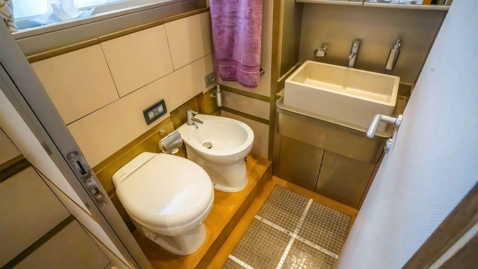 a bathroom with a toilet and sink aboard ELEGANCE OF CANNES Yacht for Sale