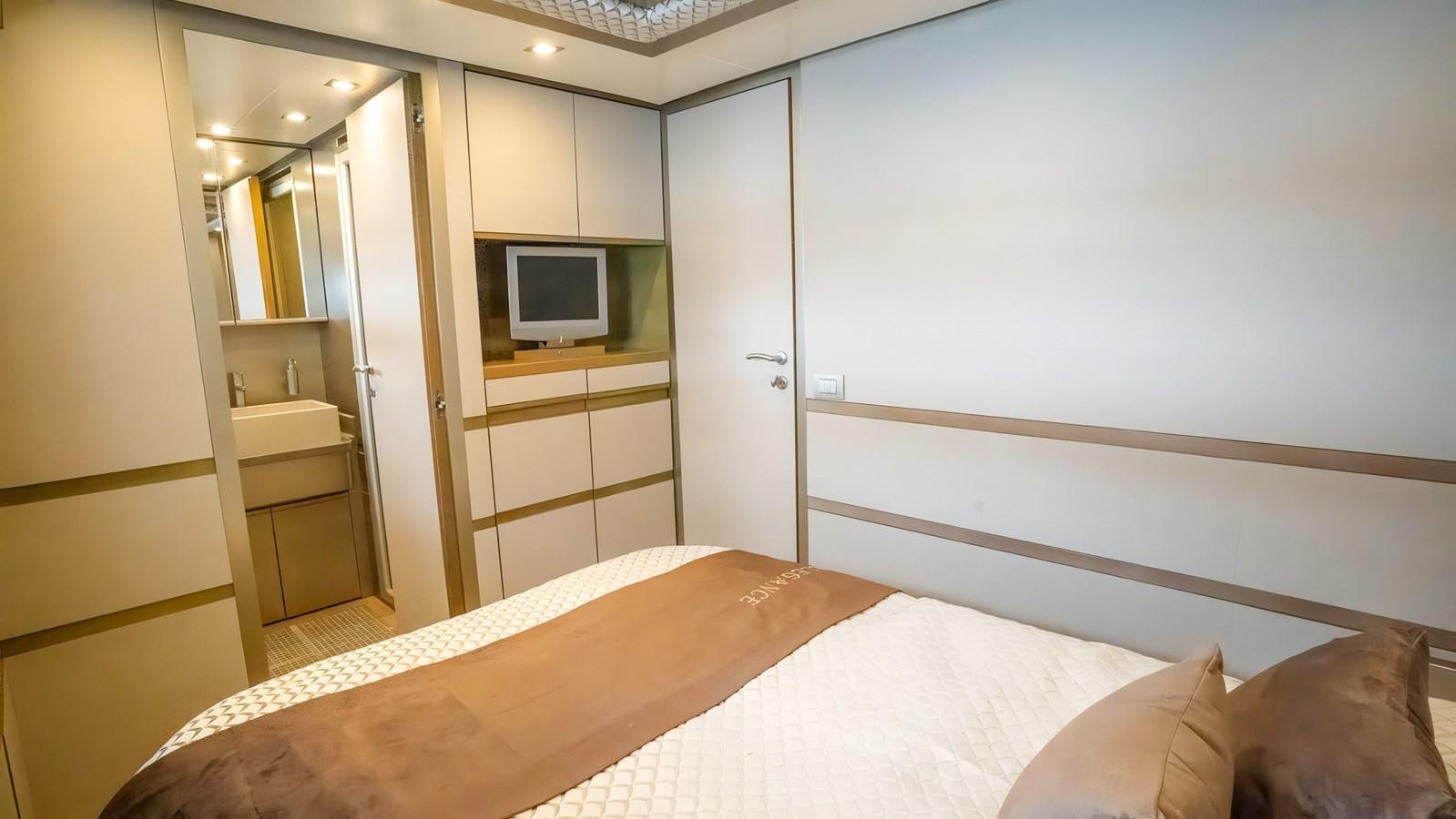 a room with a bed and a tv aboard ELEGANCE OF CANNES Yacht for Sale