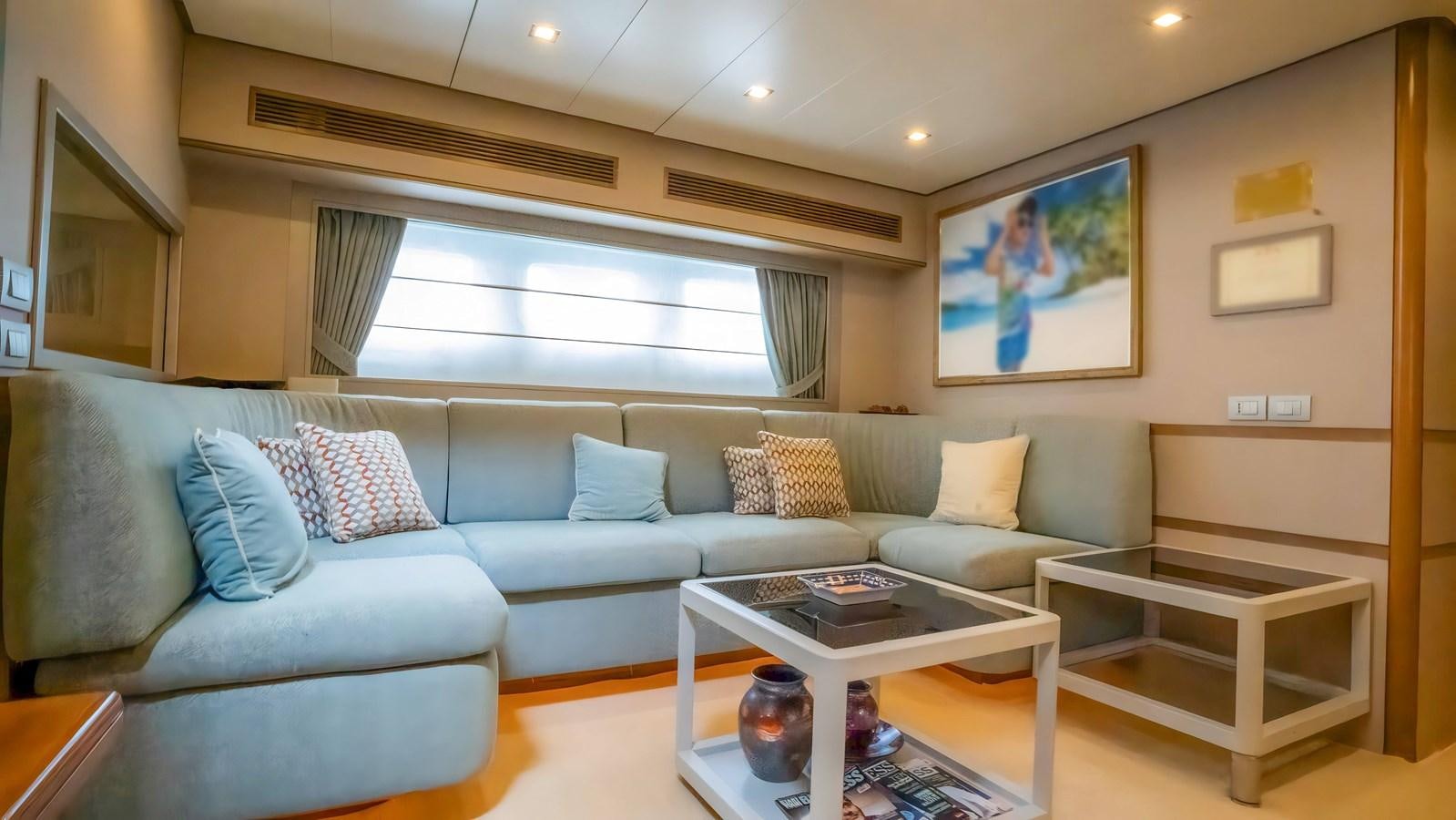 a living room with a couch and a coffee table aboard ELEGANCE OF CANNES Yacht for Sale