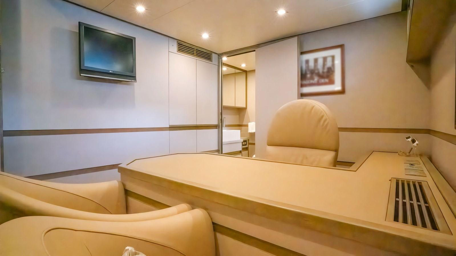 a room with a bed and a television on the wall aboard ELEGANCE OF CANNES Yacht for Sale