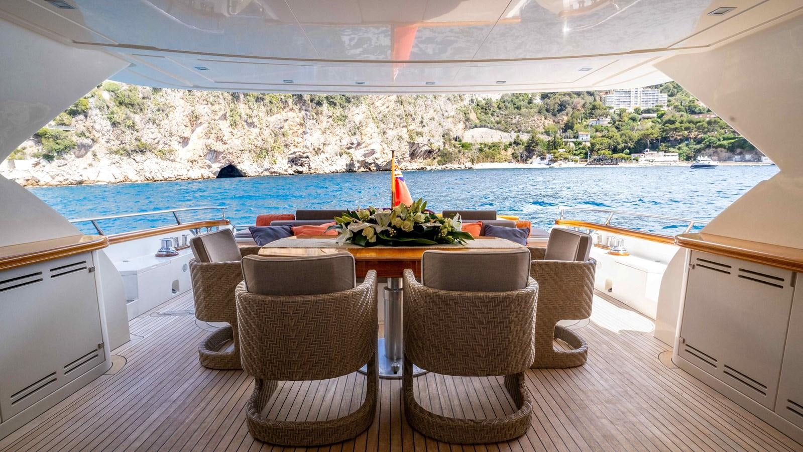 a table with chairs and a plant on it aboard ELEGANCE OF CANNES Yacht for Sale