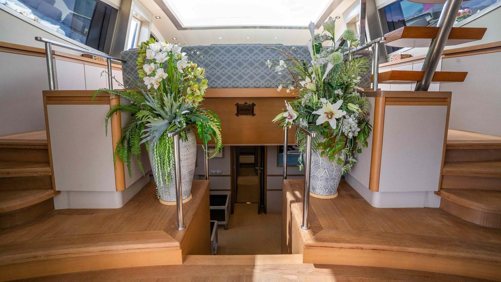a room with a few vases of flowers aboard ELEGANCE OF CANNES Yacht for Sale
