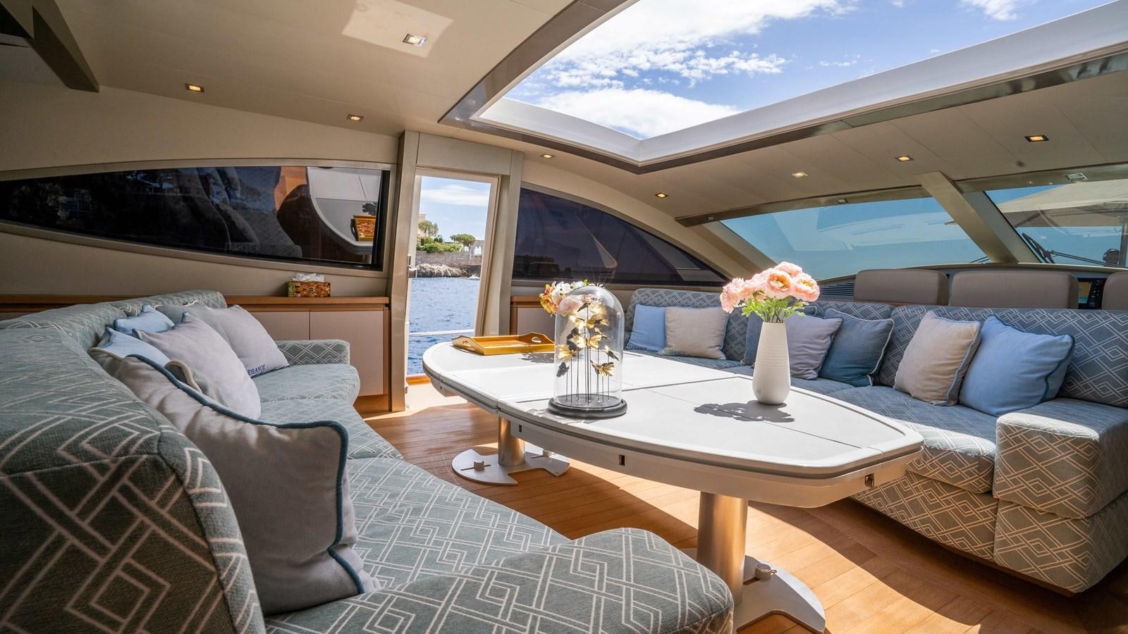 a living room with a large white table and a large window aboard ELEGANCE OF CANNES Yacht for Sale