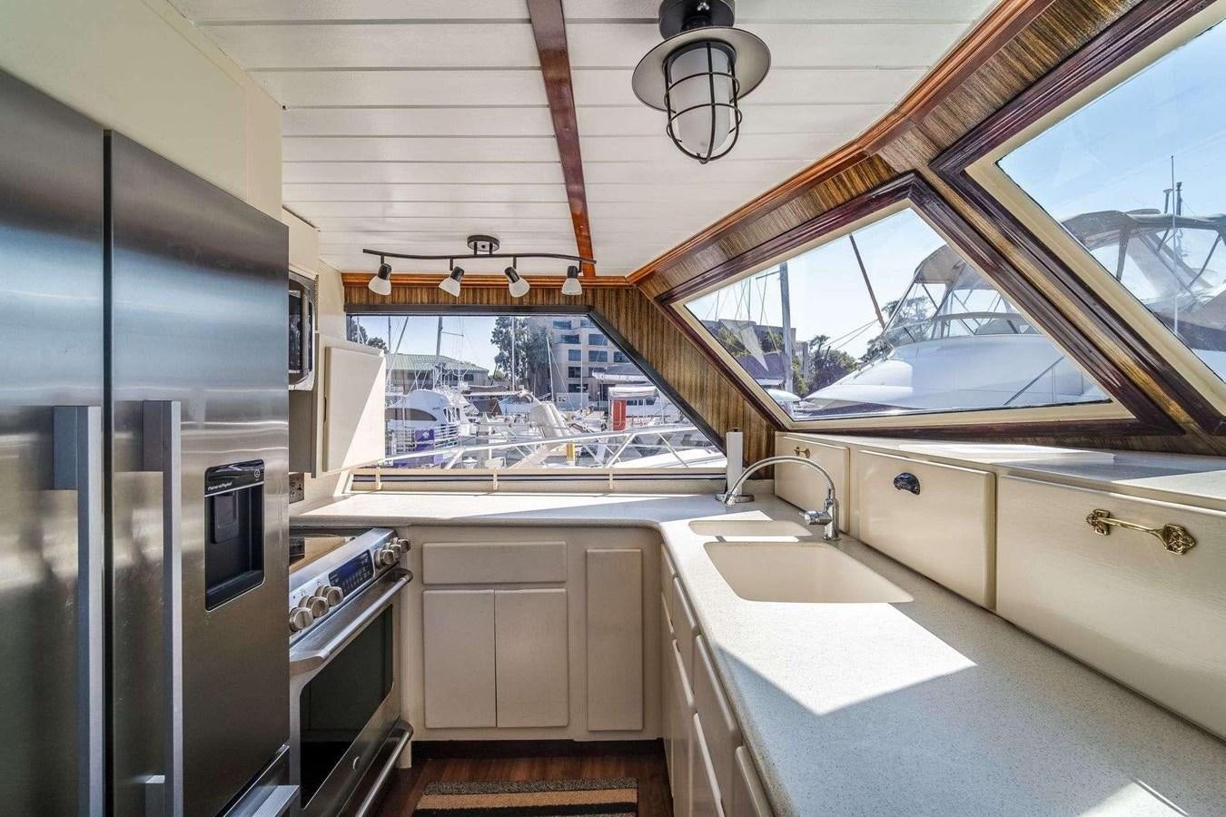a kitchen with a large window aboard SEA WOLF Yacht for Sale