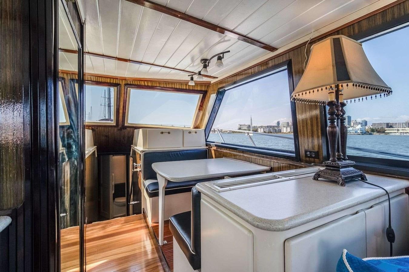 a room with a table and a lamp aboard SEA WOLF Yacht for Sale