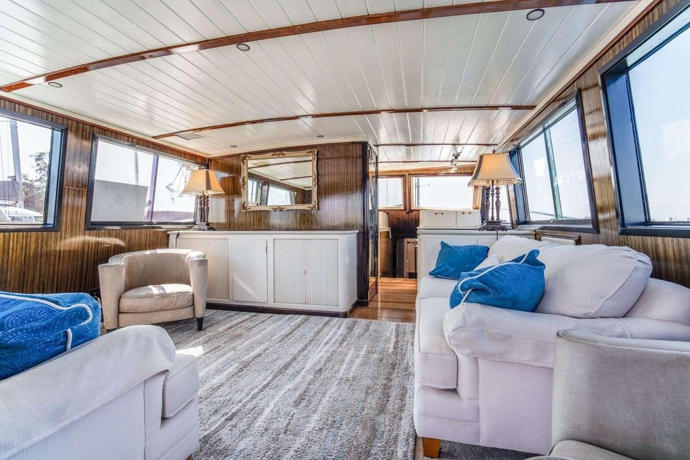 a room with a couch and a television in it aboard SEA WOLF Yacht for Sale