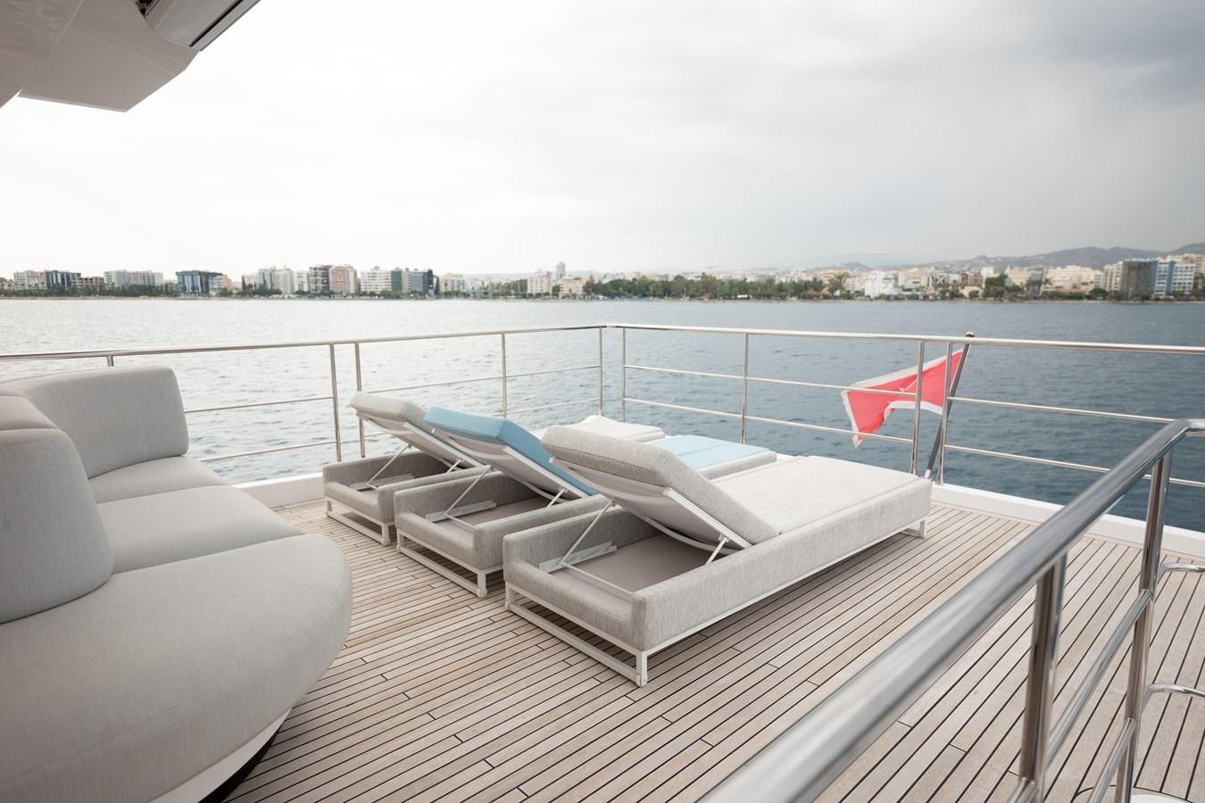 a deck with a flag on it aboard CLOUDY BAY Yacht for Sale