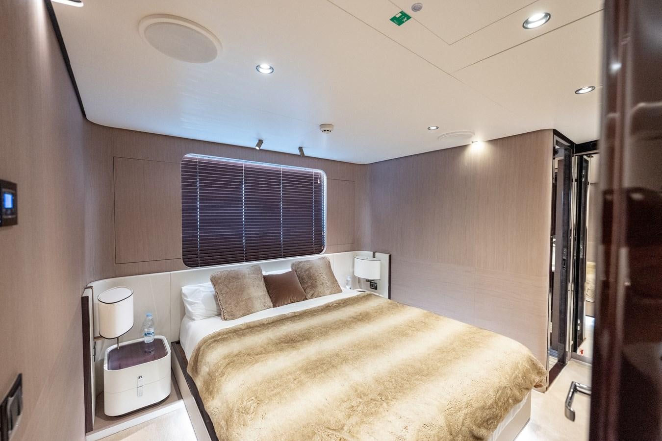 a bedroom with a bed and a window aboard CLOUDY BAY Yacht for Sale