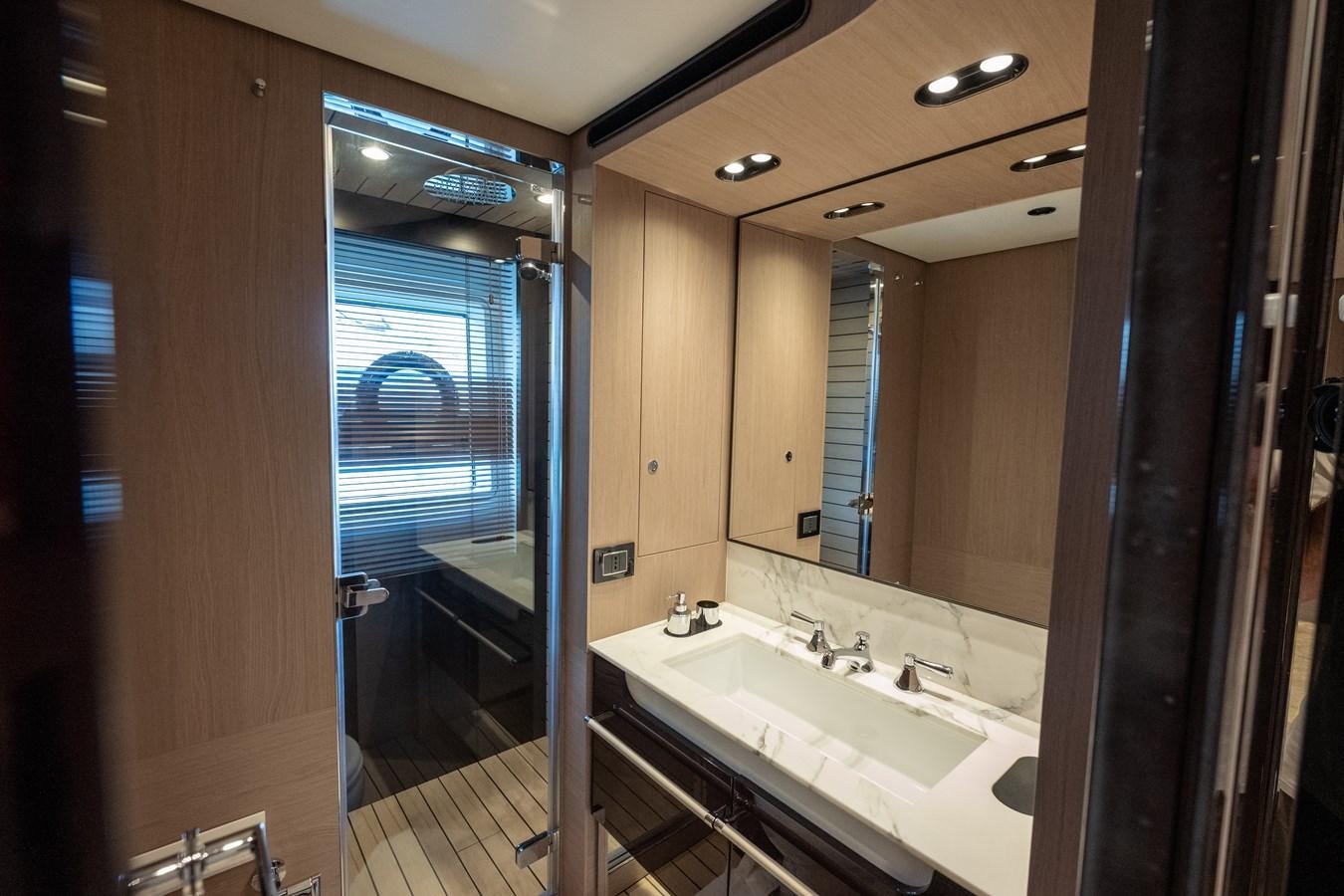 a bathroom with a large mirror aboard CLOUDY BAY Yacht for Sale