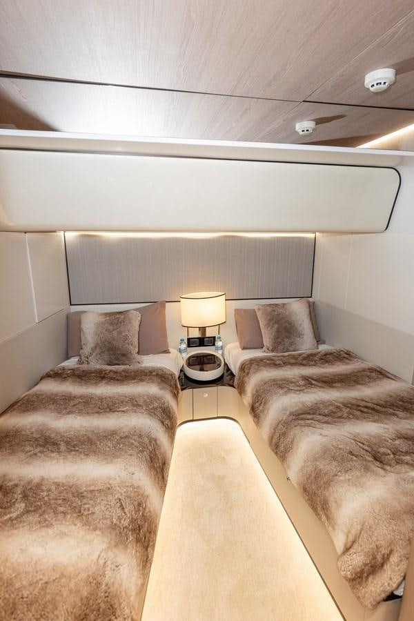 a room with a bed and a lamp aboard CLOUDY BAY Yacht for Sale