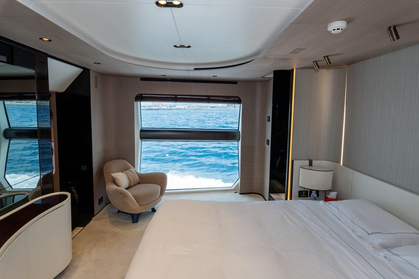 a room with a bed and a chair aboard CLOUDY BAY Yacht for Sale