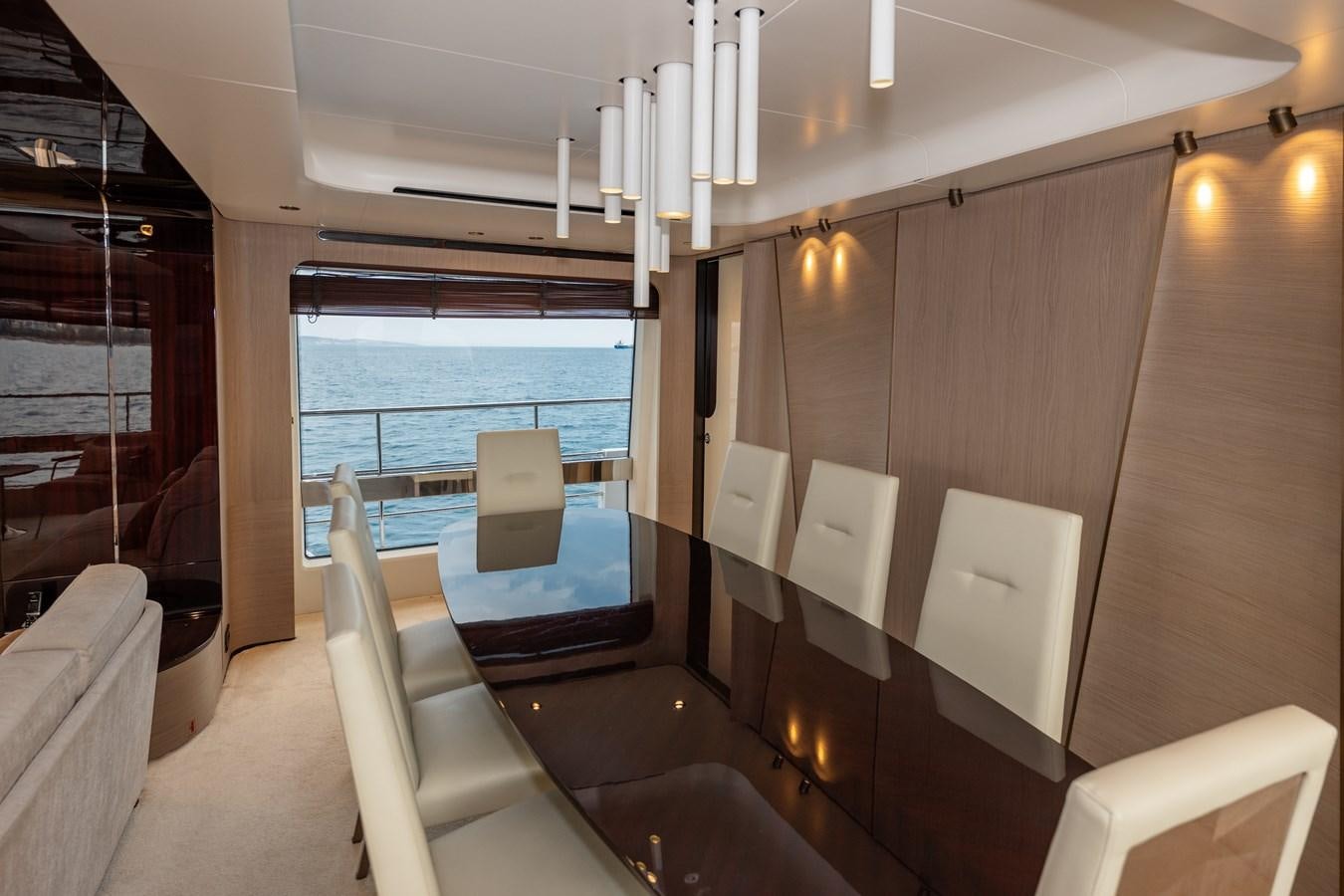 a room with a table chairs and a window aboard CLOUDY BAY Yacht for Sale
