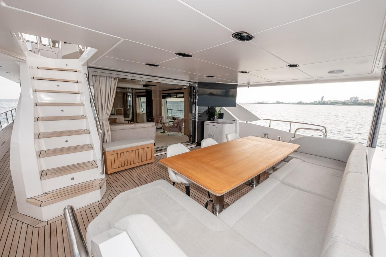 a room with a table and chairs aboard CLOUDY BAY Yacht for Sale